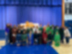 This photo links to the Saint Nicholas Catholic School Student Life page. The photo depicts 7th graders after they put on a living Stations of the Cross during Lent.
