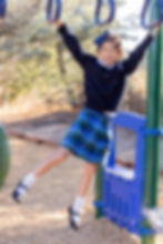 A girl smiles as plays on the monkey bars at recess at Saint Nicholas Catholic School in Los Altos, California.