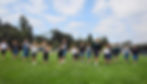 A group of Saint Nicholas Catholic School children playing on a large field, part of our 17 acre campus.