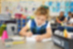 A first grade girl works writes in her notebook at Saint Nicholas Catholic School in Los Altos California.