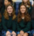 A link to the Saint Nicholas Catholic School High School Acceptances Page. The photo shows two middle-school girls smiling at a mass.