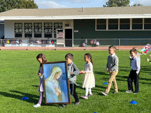 Kindergarteners lead the procession for our May Crowning at Saint Nicholas Catholic School