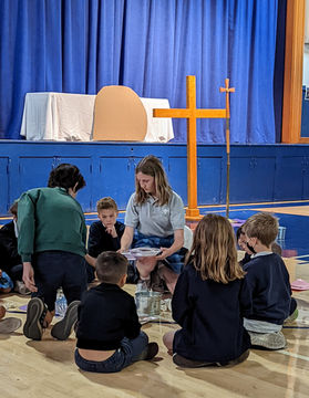 An 8th grade students directing her faith family at an Lenten prayer service at Saint Nicholas School in Los Altos, California