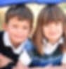A link to the Saint Nicholas Catholic School Transitional Kindergarten and Kindergarten academics page. The image shows three students, a boy and two girls, smiling at the camera.