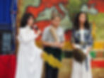 This image links to the Capital Campaign page of the Saint Nicholas School website. It depicts three 6th grade students dressed up as ancient gods  acting out a skit during the 6th grade annual "Walk through the Ancient World" active learning event.