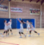 This photo links to the Saint Nicholas Catholic School Athletics and Sports page. It depicts the 4th grade girls' volleyball team celebrating after a teammate scores a point.