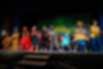 4th - 8th grade students dance and sing in bright costumes on stage  in Suessical the Musical. Saint Nicholas Catholic School's has a proud tradition of  theater productions.