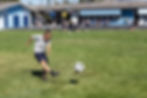 An elementary school aged boy kicks a soccer ball in one of the after-school sports programs for students in Koffered at Saint Nicholas through 4th grade at Saint Nicholas Catholic School
