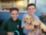Two students bring their pet dog to be blessed on October 4, the feast of Saint Francis, at Saint Nicholas Catholic School in Los Altos California