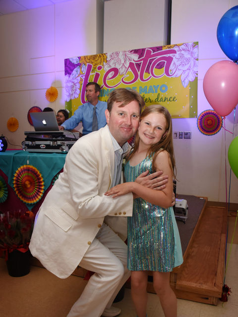 A father and a daughter hug at Saint Nicholas Catholic School's Annual Father-Daughter Dance.