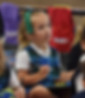 A link to the admissions page; the image shows a student in kindergarten at Saint Nicholas Catholic School in Los Altos  holding a pen and a personal white board and listening to her teacher.