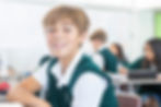 A middle school student, a boy, smiles at Saint Nicholas Catholic School in Los Altos California