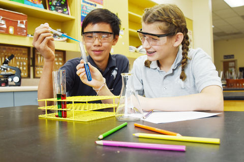 Two middle school students do a chemistry experiment at Saint Nicholas Catholic School