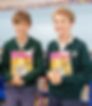 This photo links to the Saint Nicholas Catholic School Tours and Open Houses page. It depicts two middle-school students, boys,  holding books and smiling.