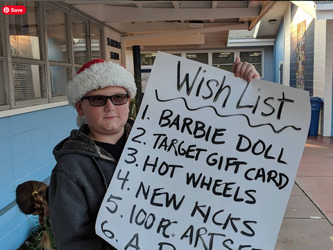 Saint Nicholas Catholic School students host Toy and other Drives throughout the years. Here, a student advertises our Annual Toy Drive in our morning drop-off line.